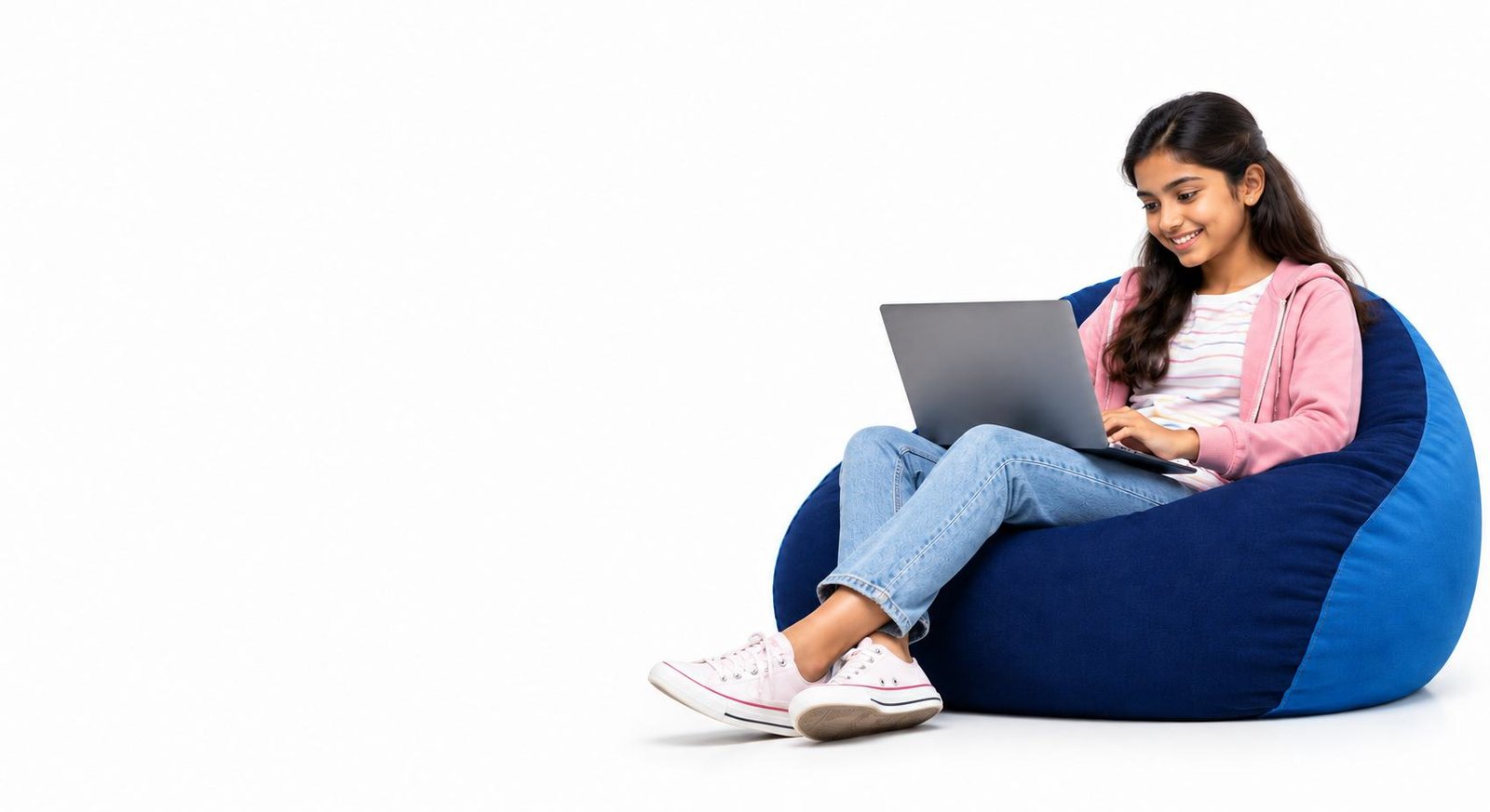 Student learning with laptop on beanbag